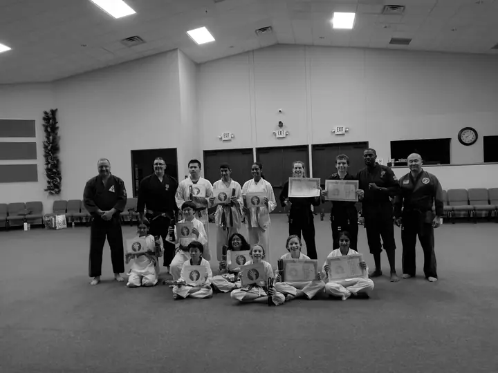 Fulshear Family Karate students holding certificates with their instructors