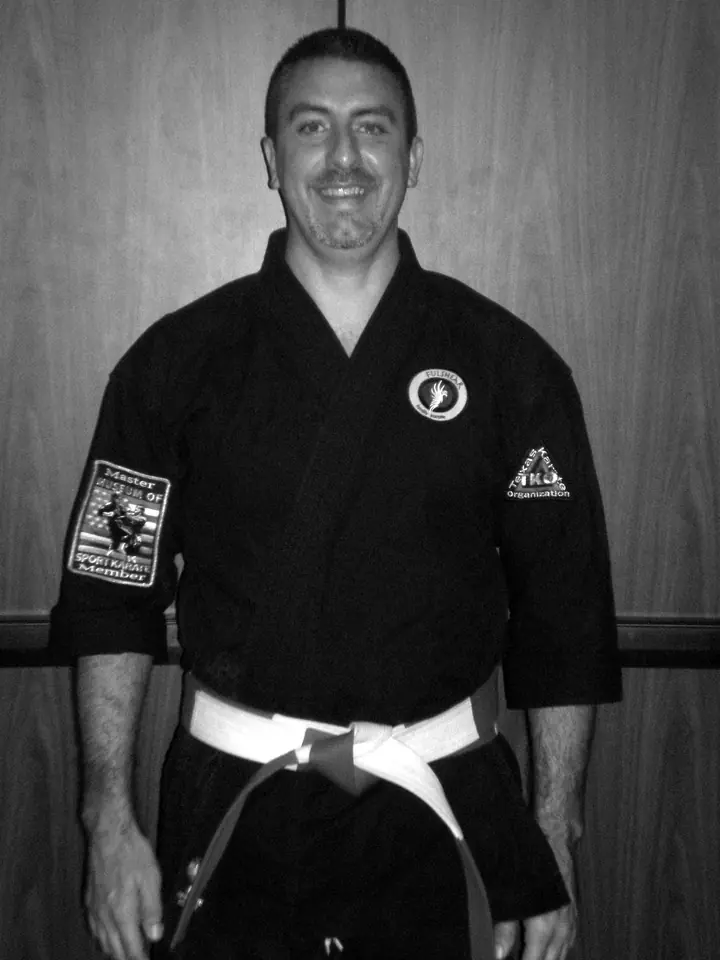 Master Wade Kirkpatrick in a black karate uniform